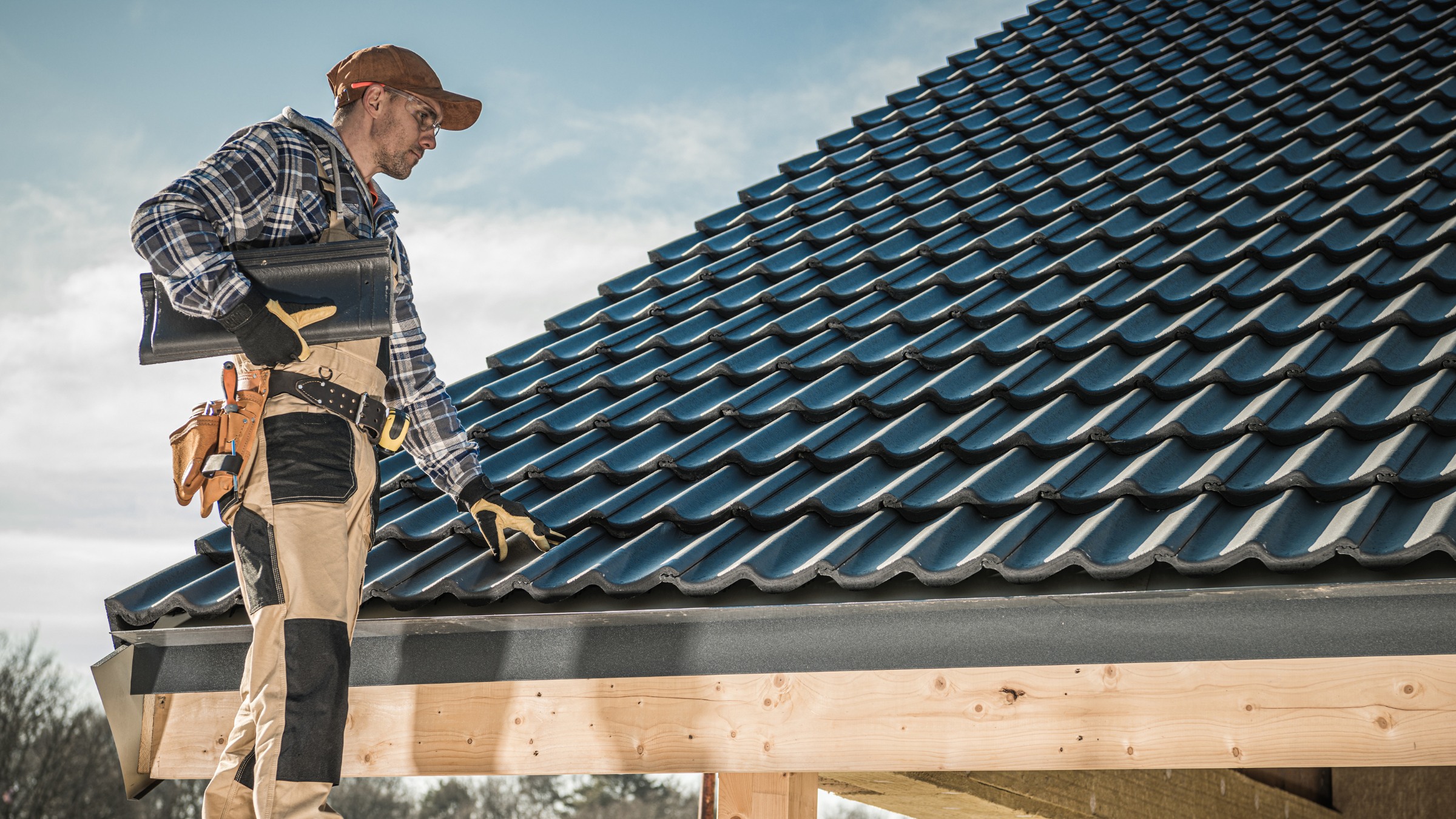 Professional roofer on roof